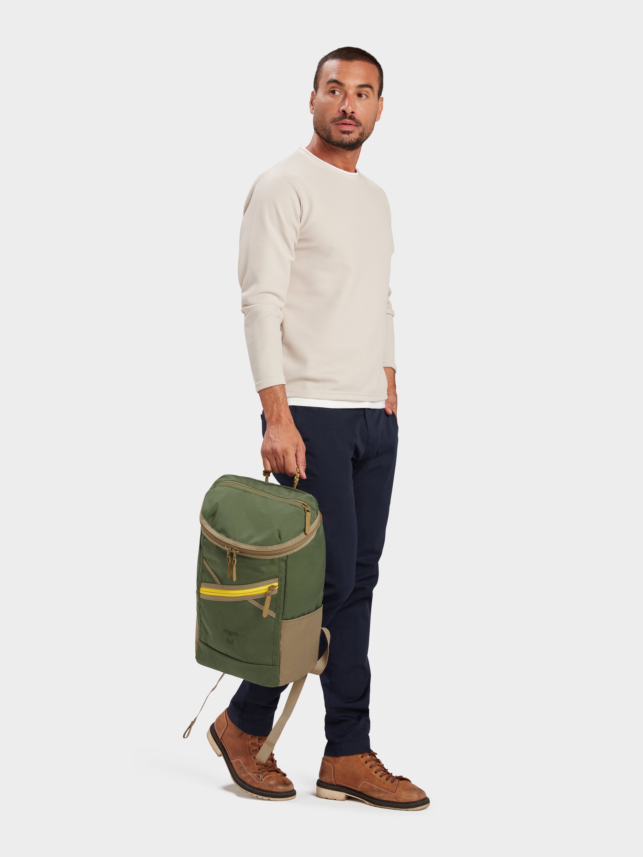 Bold backpack in camo green carried by model