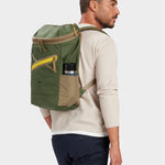 Bold backpack in camo green carried by model