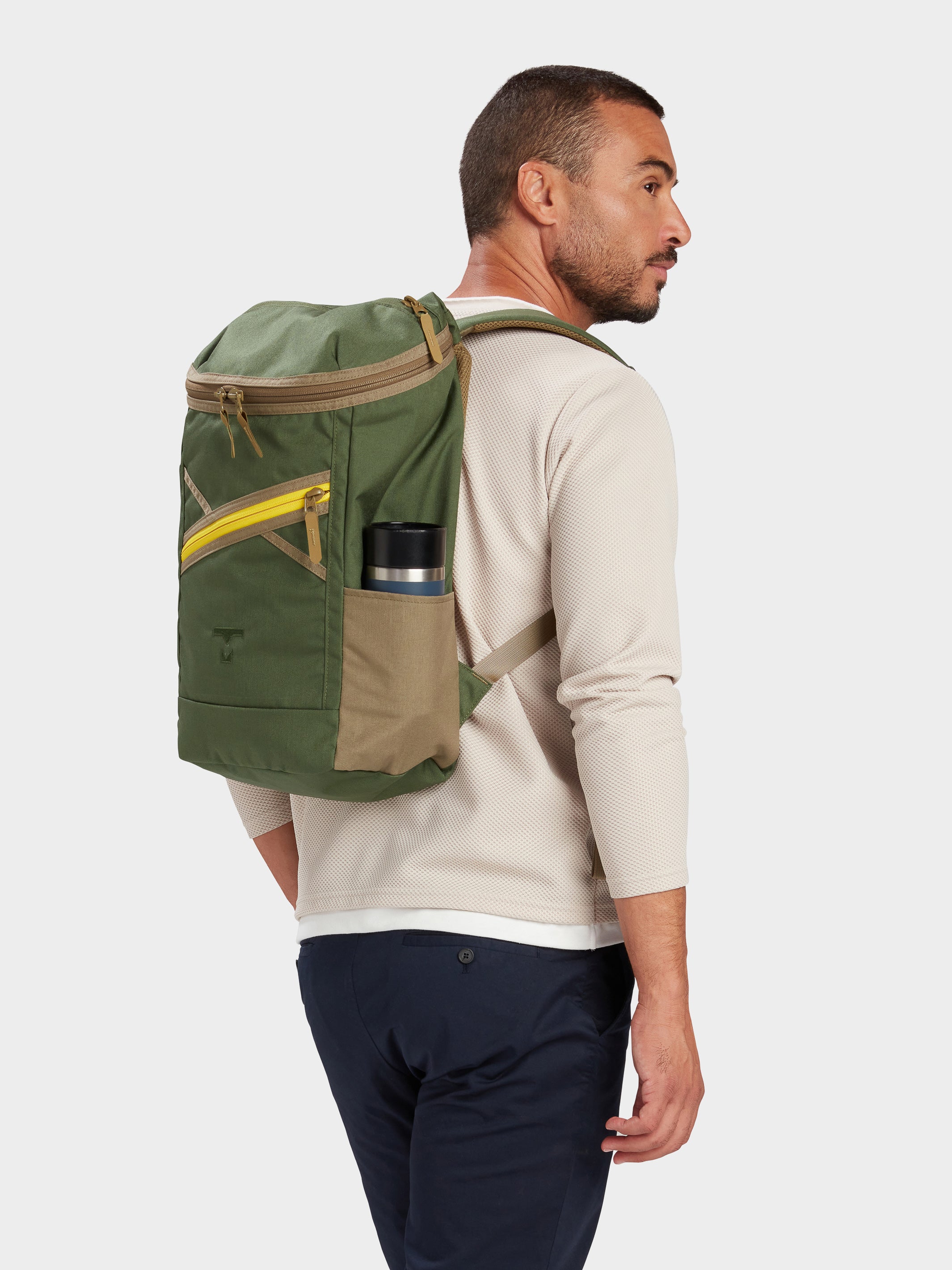 Bold backpack in camo green carried by model