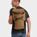 Bold backpack in coyote brown carried by model