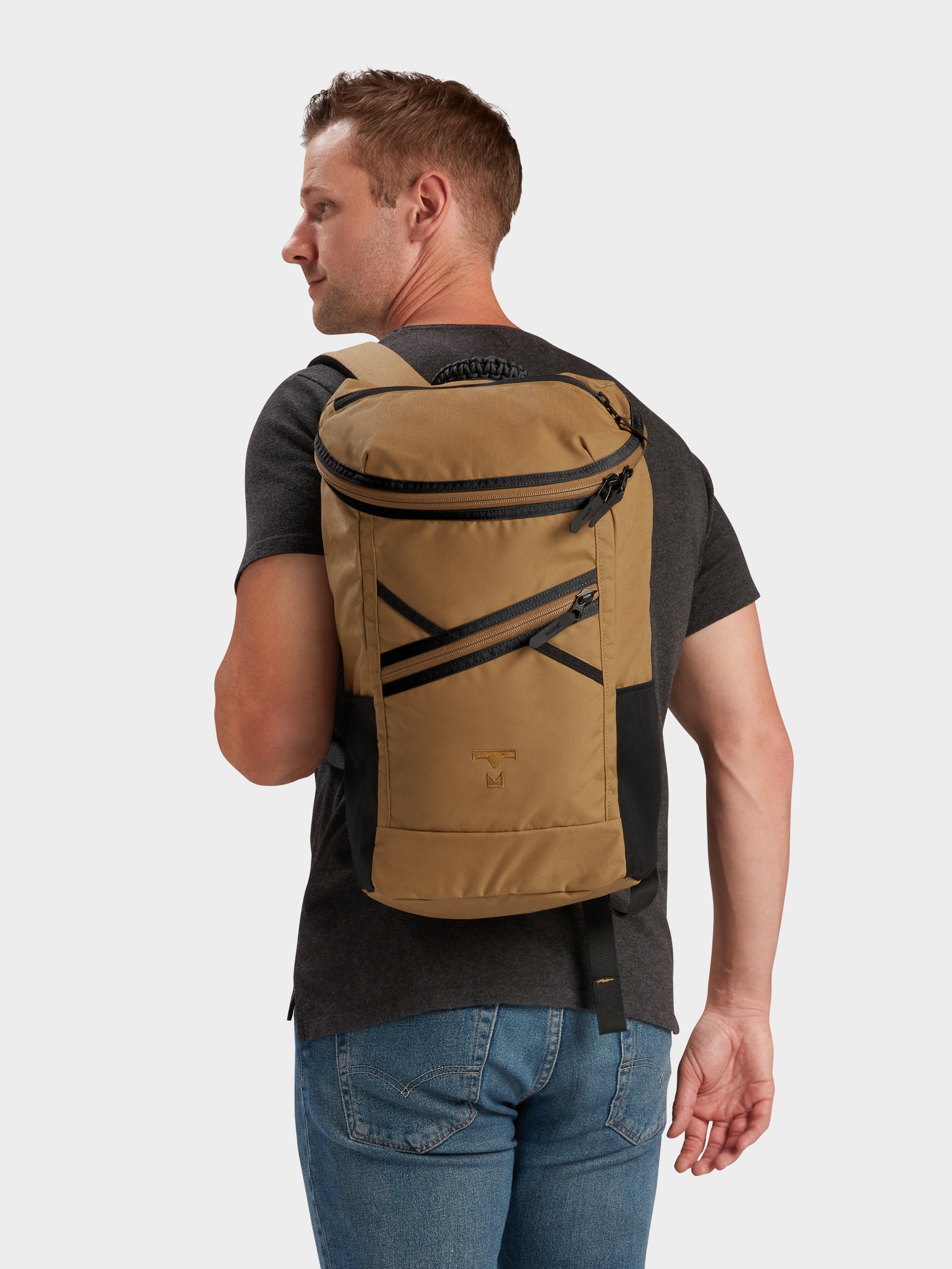 Bold backpack in coyote brown carried by model