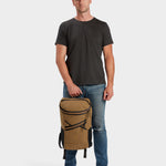 Bold backpack in coyote brown carried by model