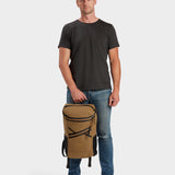 Bold backpack in coyote brown carried by model