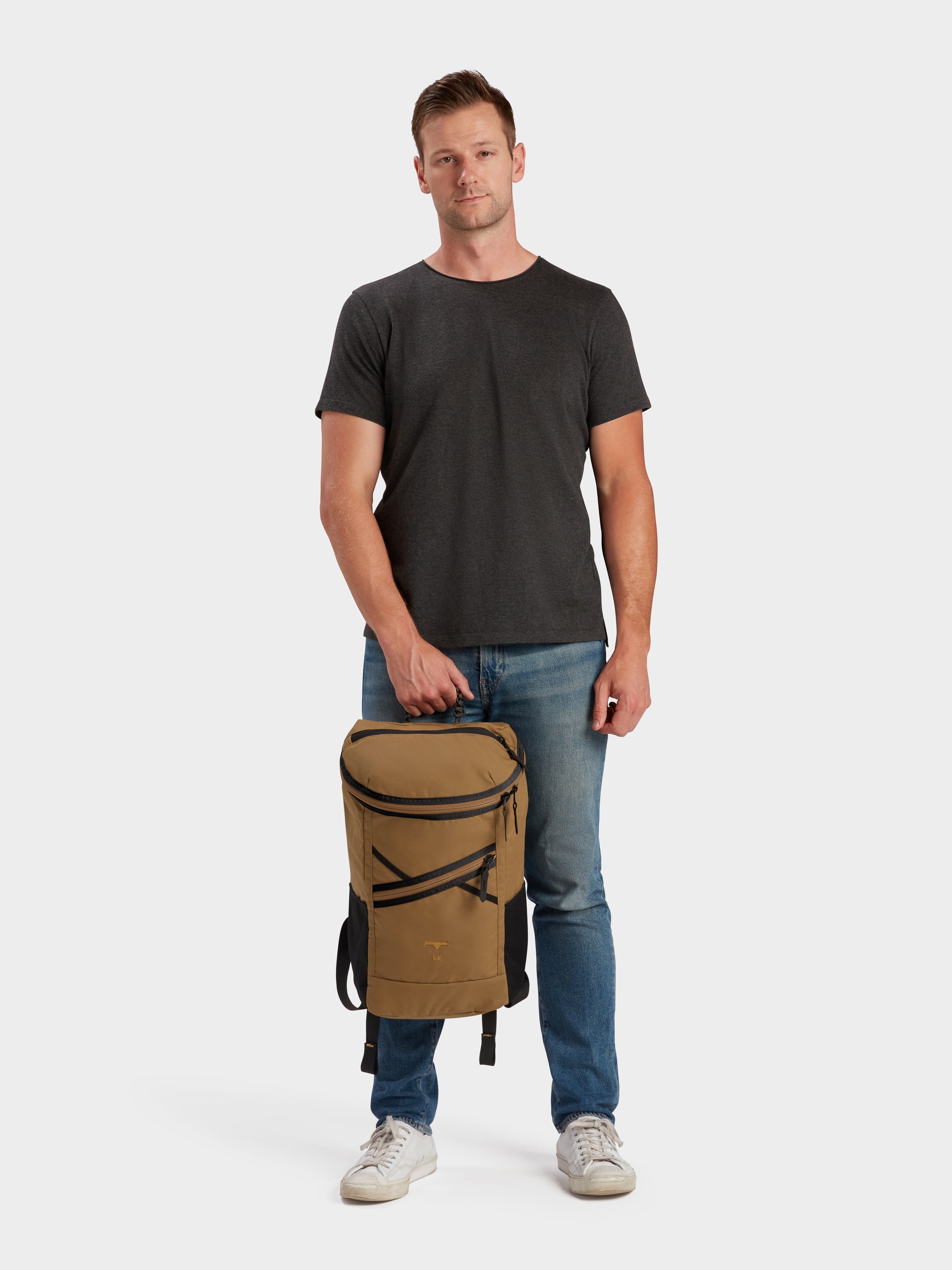 Bold backpack in coyote brown carried by model