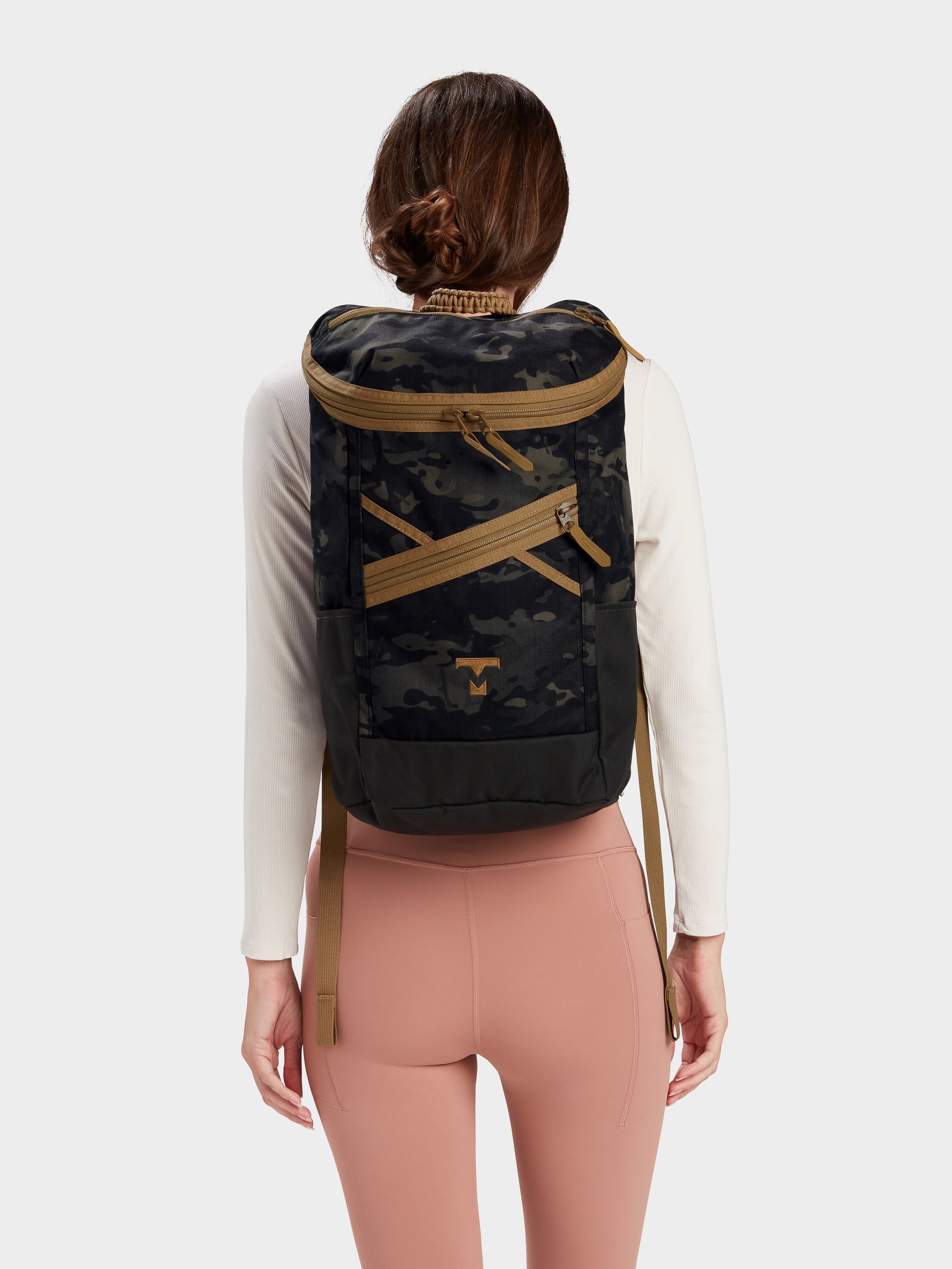 Bold backpack in multicam black carried by model