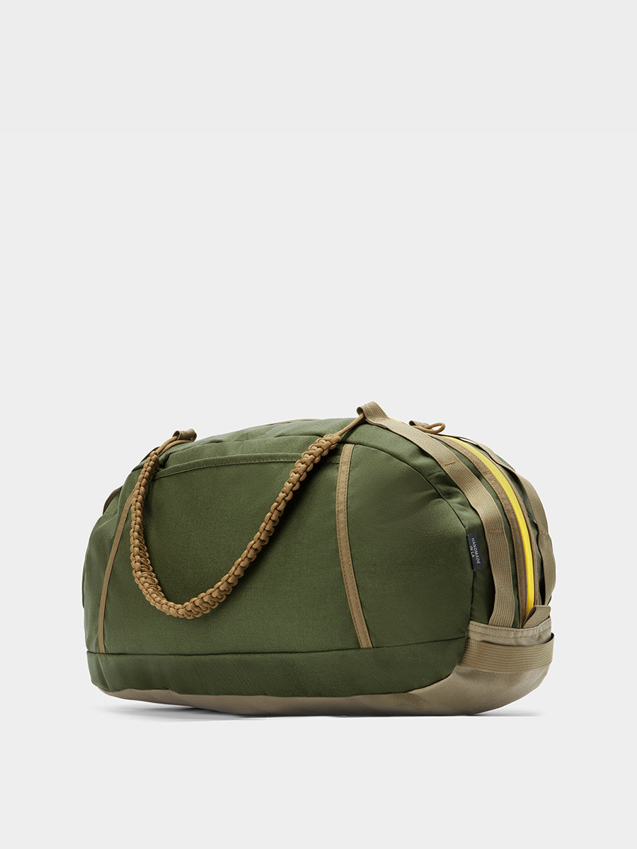 Grit duffle in camo green tabletop in back 45 degree view