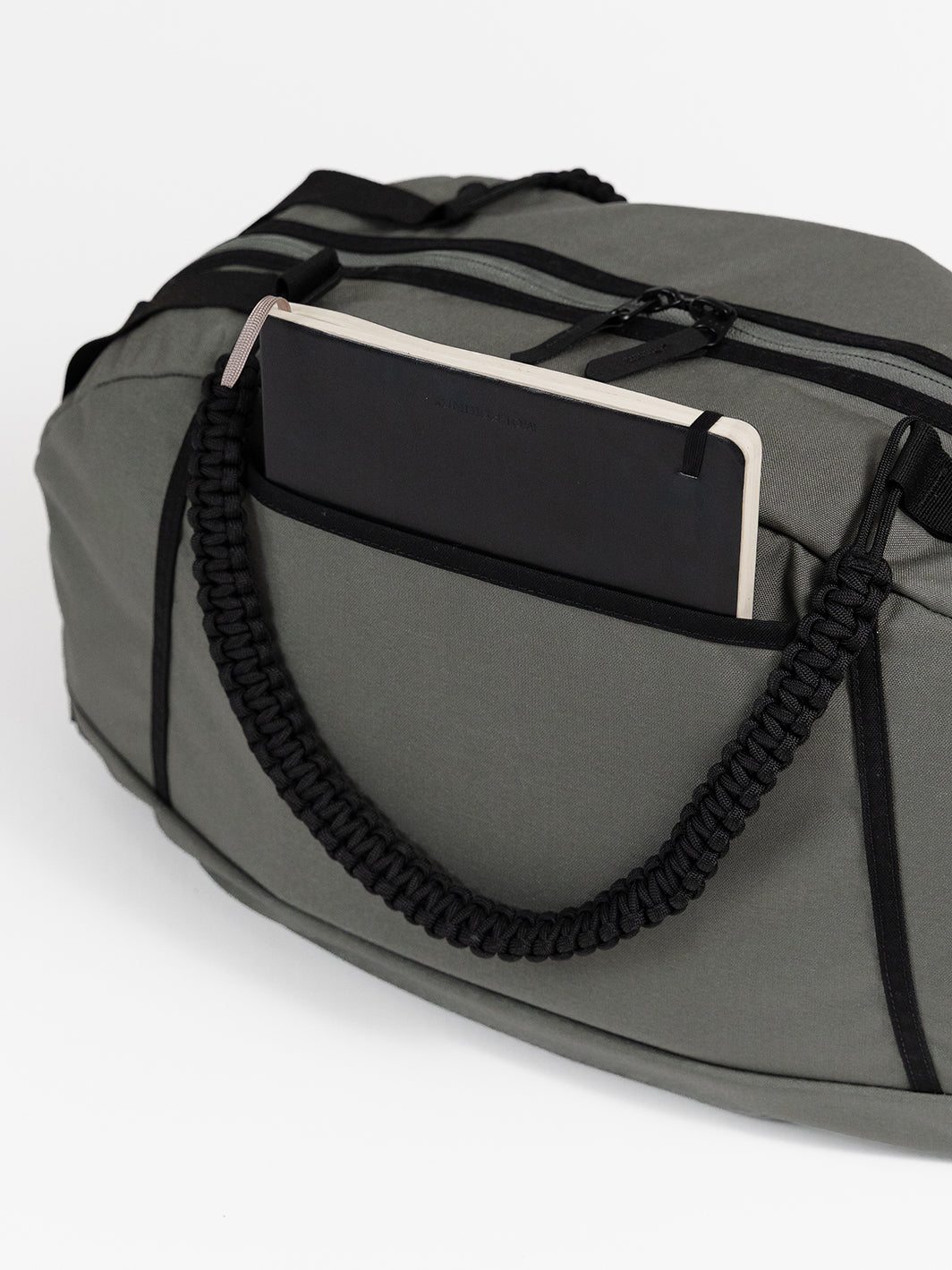 MILTHREAD Grit Duffel 25L travel bag features back pocket for quick access