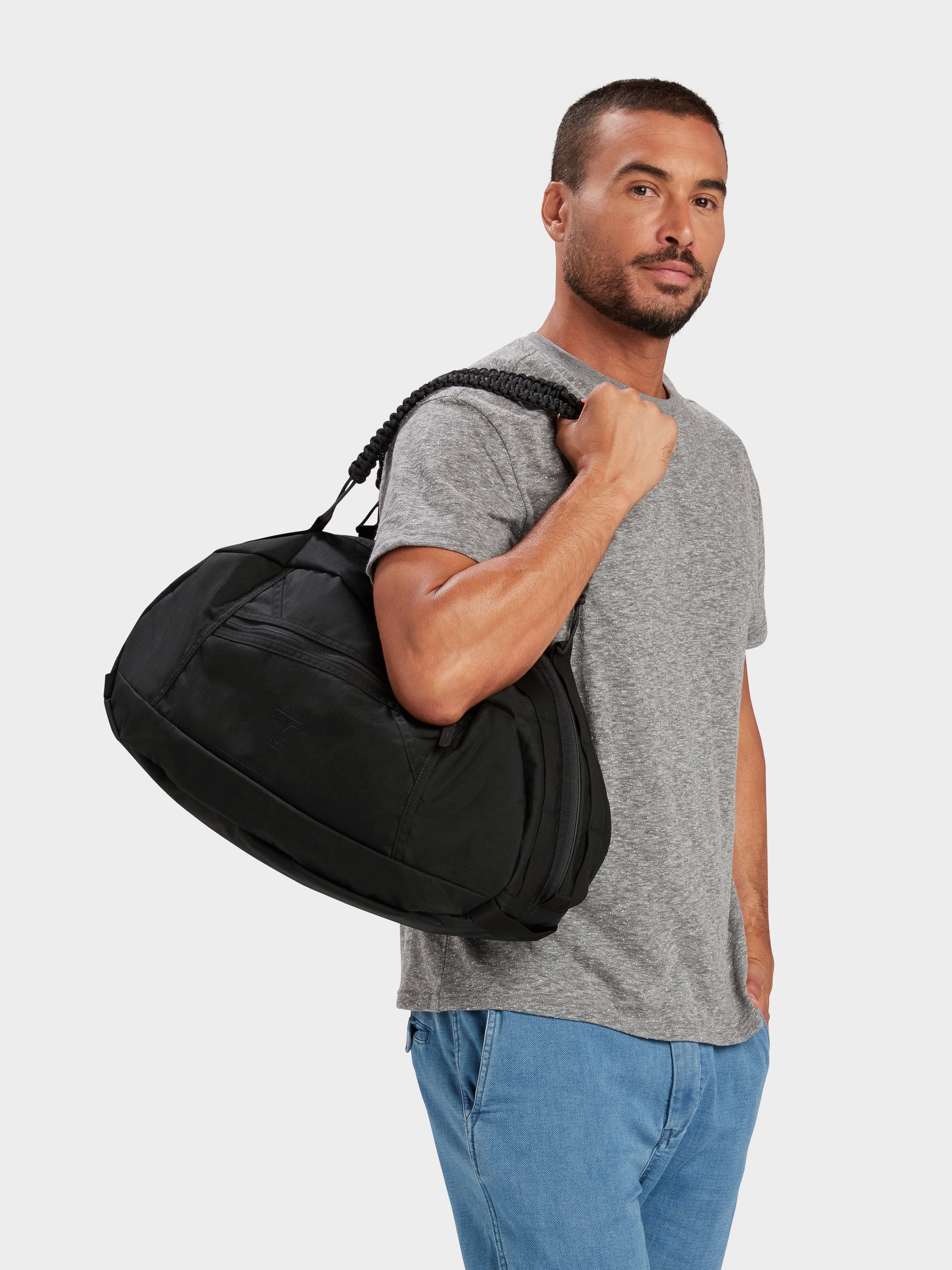 Grit duffle in black carried by model