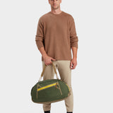 Grit duffle in camo green carried by model