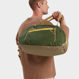 Grit duffle in camo green carried by model