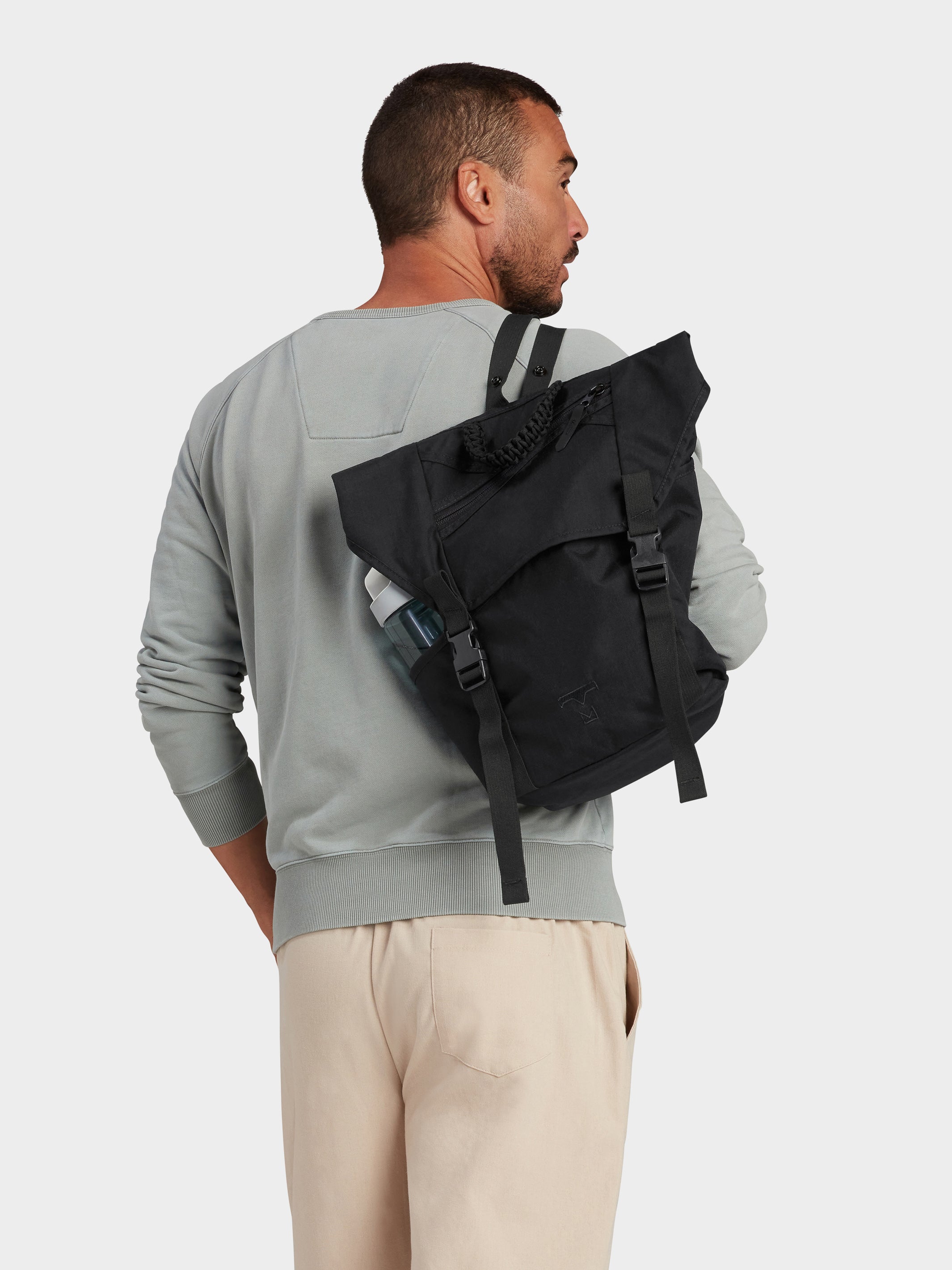 Swift backpack in black carried by model