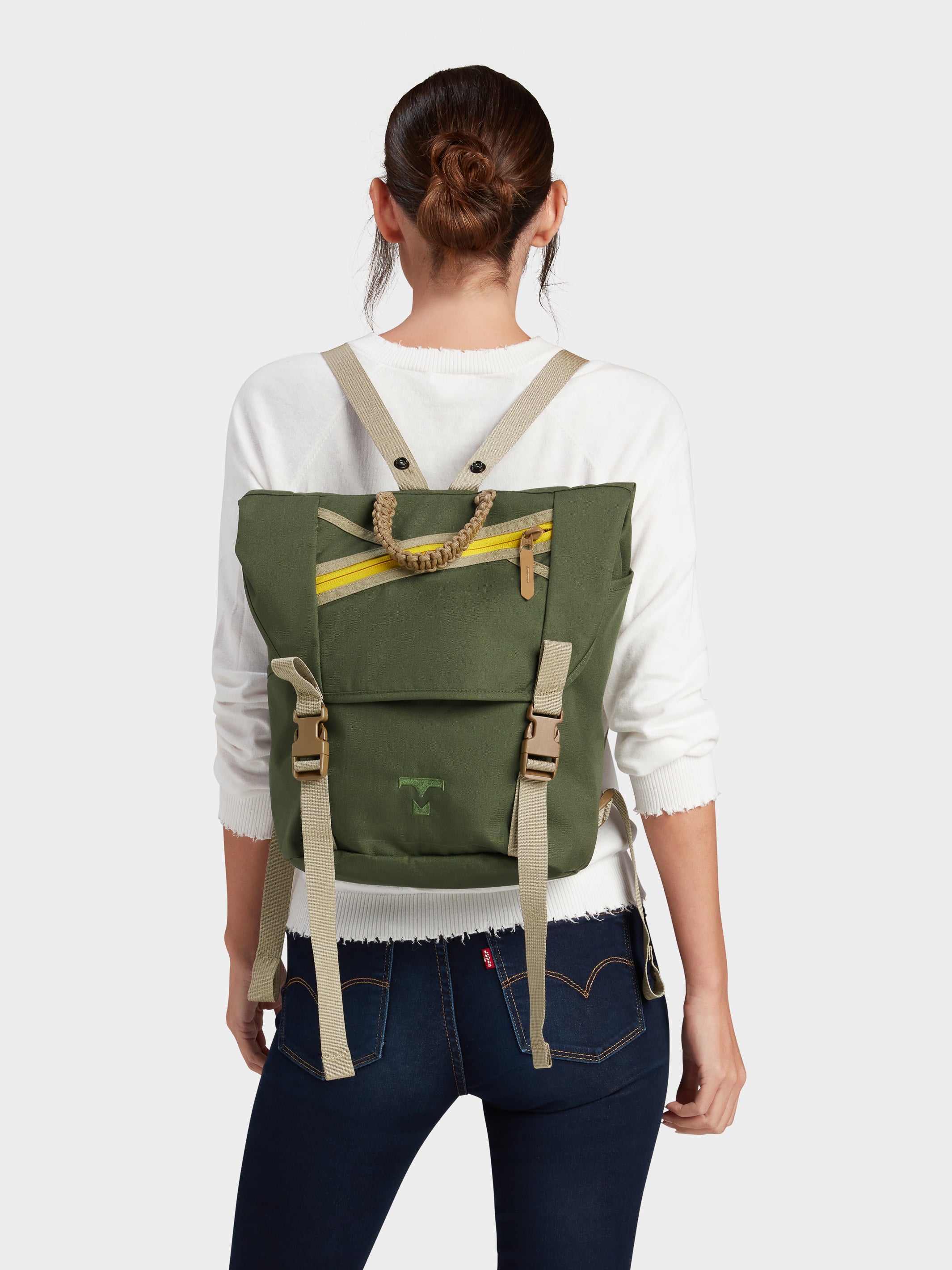 Swift backpack in camo green carried by model