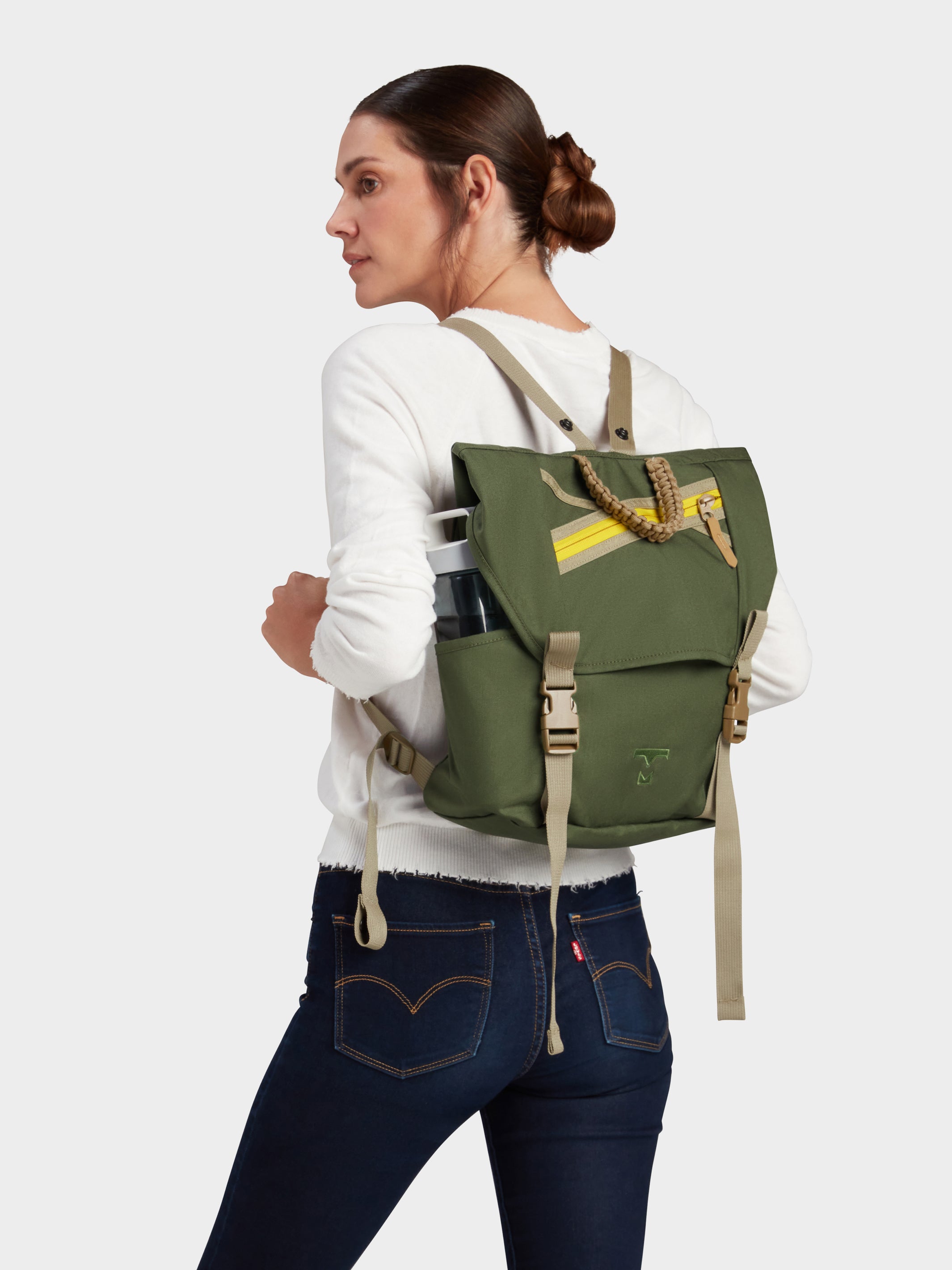 Swift backpack in camo green carried by model