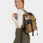 Swift backpack in coyote brown carried by model