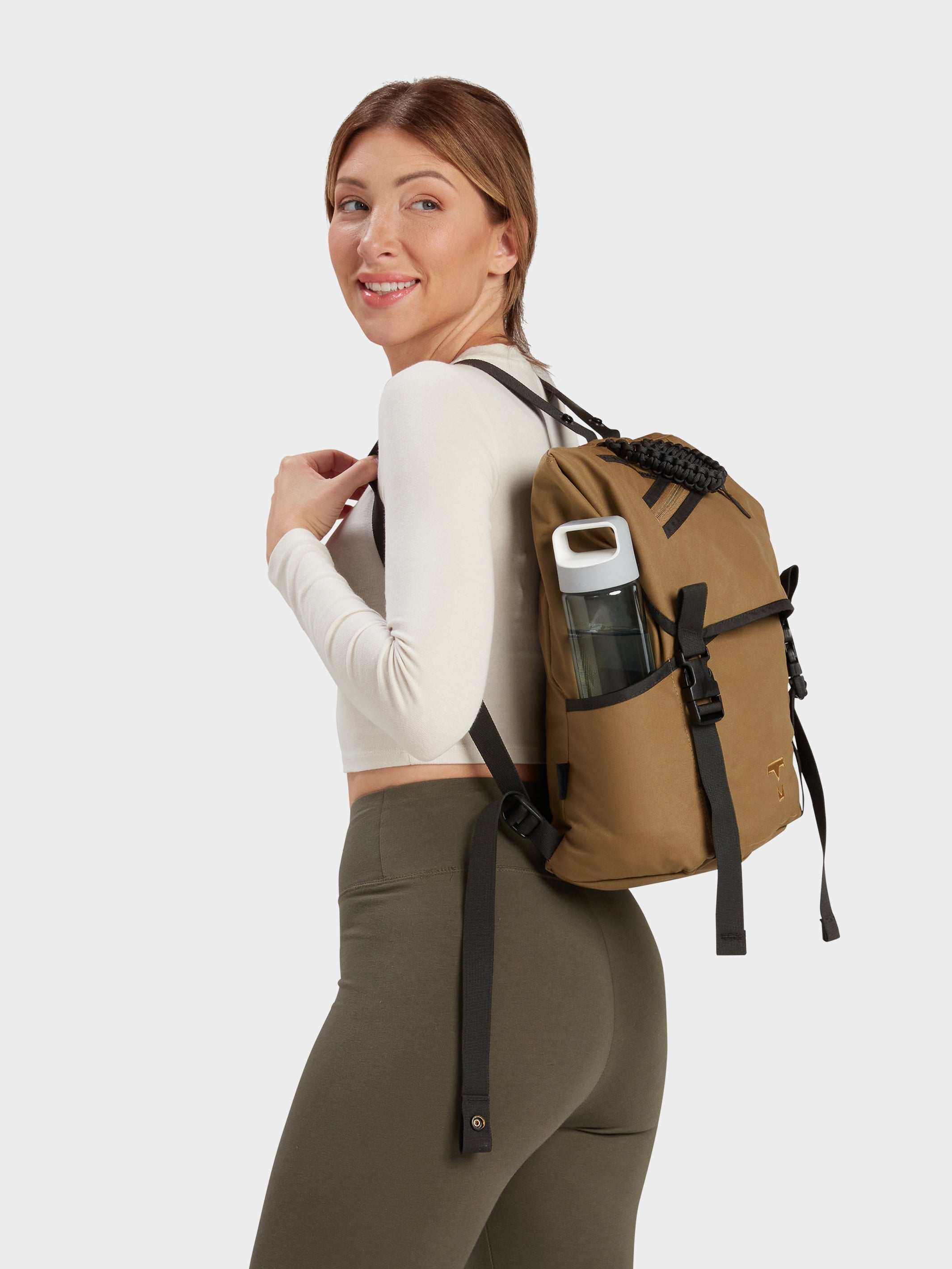 Swift backpack in coyote brown carried by model