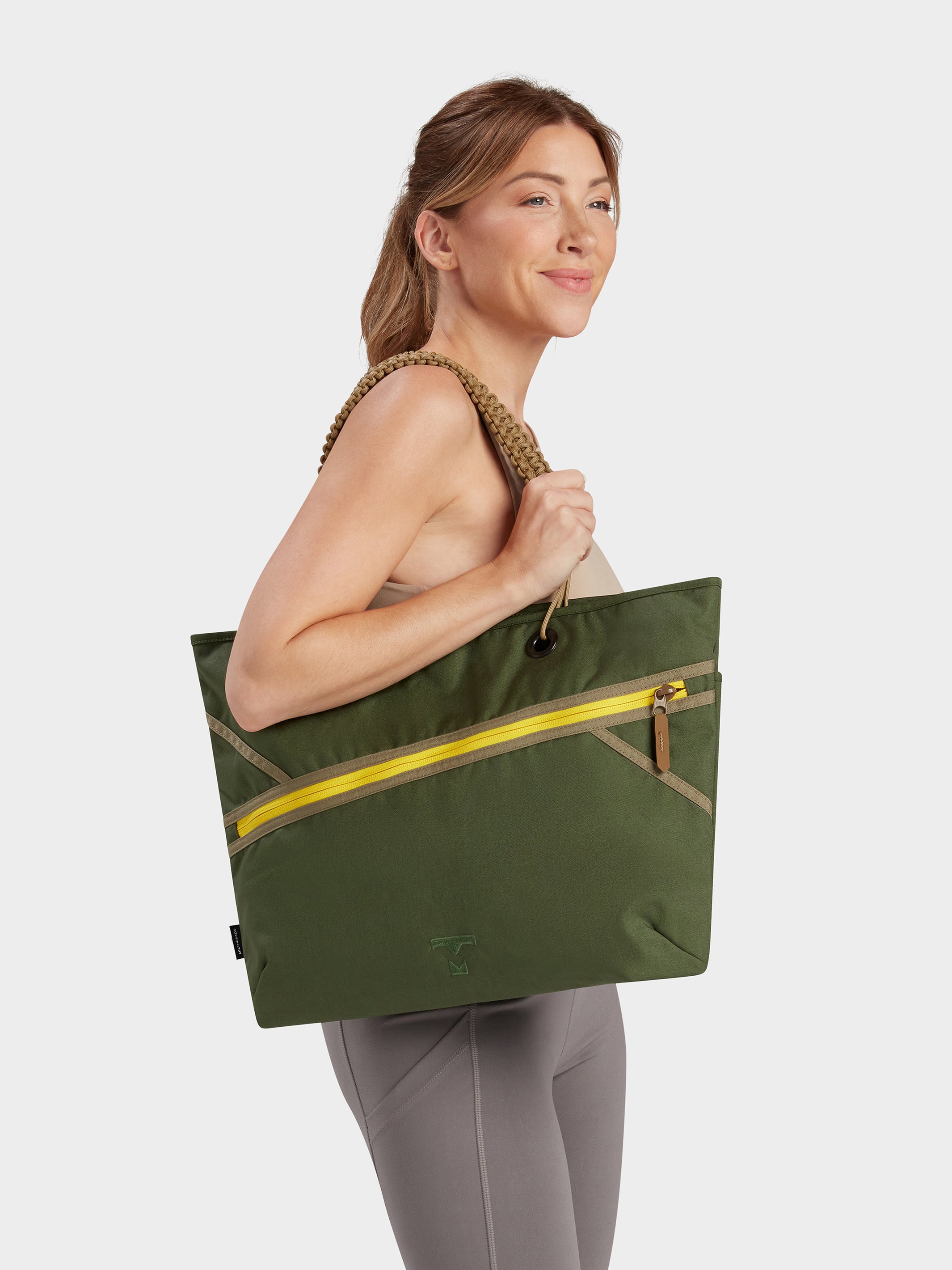 Zing tote in camo green carried by model