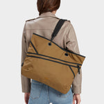 Zing tote in coyote brown carried by model