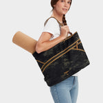 Zing tote in multicam black carried by model