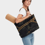 Zing tote in multicam black carried by model