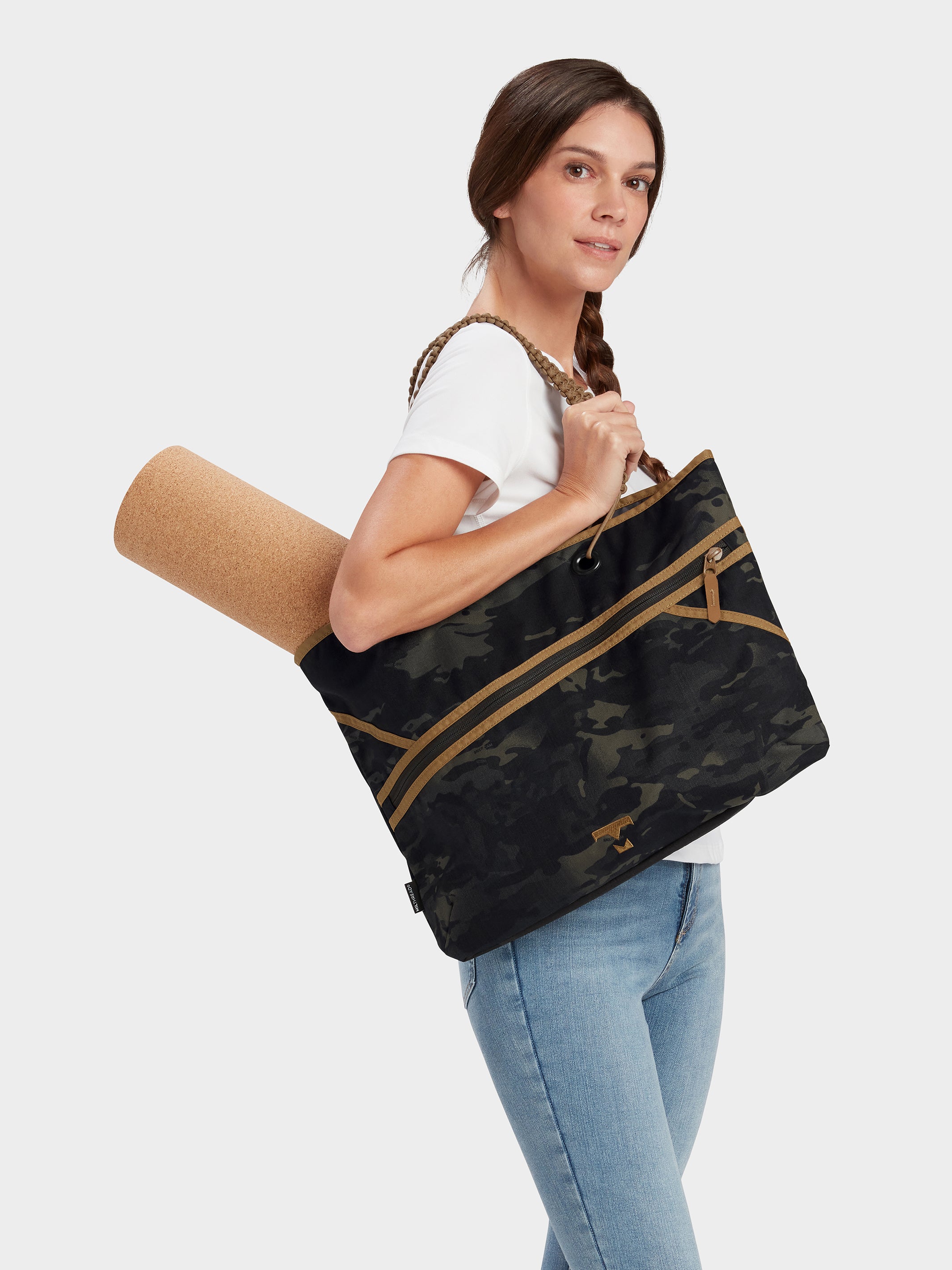 Zing tote in multicam black carried by model